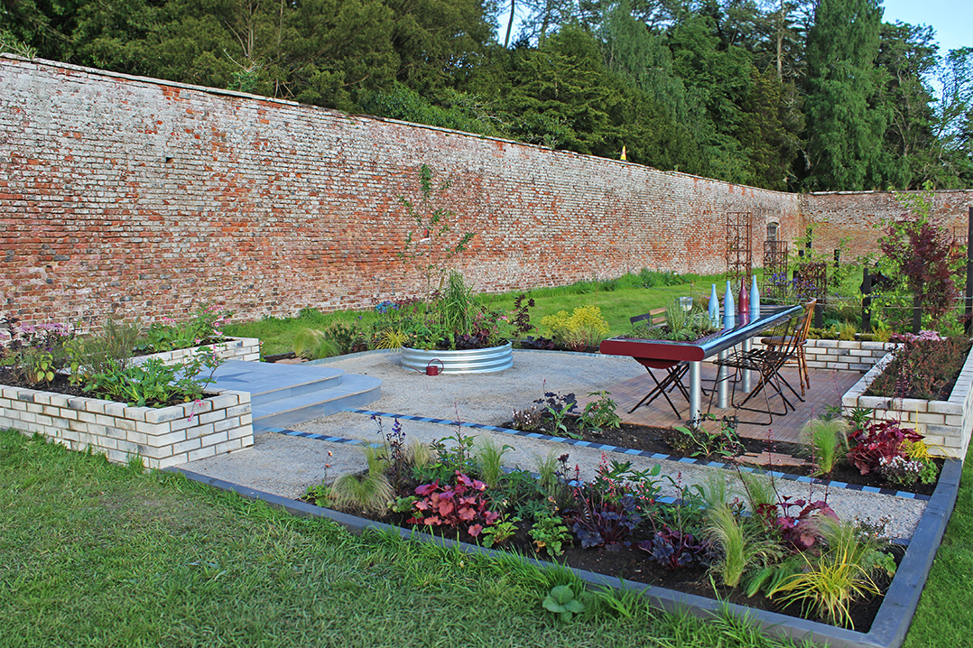 The Dinner Party Garden by Laura Stevenson. This award-winning show garden is set in the walled garden at Scone Palace and features a zinc-plated table, a raised platform and planting.